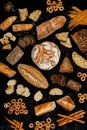 Assortment of different types of bread on a black background. Top view Royalty Free Stock Photo