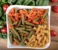 Assortment of different types of gluten-free penne pasta from chickpeas, red lentils, peas