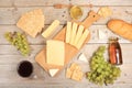 Assortment of different varieties of cheese, red wine, grapes and cracker, the basis of the French diet, healthy and natural food Royalty Free Stock Photo