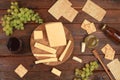 Assortment of different varieties of cheese, red wine, grapes and cracker, the basis of the French diet, healthy and natural food Royalty Free Stock Photo