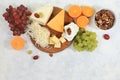 Assortment of different varieties of cheeses, grapes and nuts, fruits, the basis of the French diet, healthy and natural food Royalty Free Stock Photo