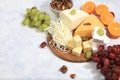 Assortment of different varieties of cheeses, grapes and nuts, fruits, the basis of the French diet, healthy and natural food Royalty Free Stock Photo