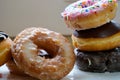 Assortment of donuts of different flavors in a box. Close-up of tasty doughnuts with sprinkles on table