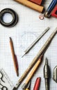 An assortment of drafting tools on graph paper for design and engineering projects Royalty Free Stock Photo