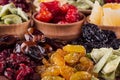 Assortment of dried fruits closeup on brown wooden background. Royalty Free Stock Photo