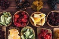 Assortment of dried fruits in spoons, bowls on brown wooden background. Royalty Free Stock Photo