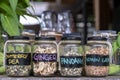 Assortment of dried spices in glass bottles on wooden background. Dry ginger, pandanus, lemon grass and butterfly pea in glass Royalty Free Stock Photo