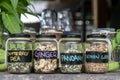 Assortment of dried spices in glass bottles on wooden background. Dry ginger, pandanus, lemon grass and butterfly pea in glass Royalty Free Stock Photo