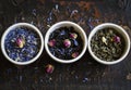 Assortment of dried tea in white bowls