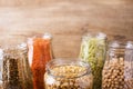 Assortment of dry organic beans and lentils in glass jars . Variety of raw legumes.