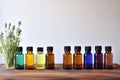 assortment of essential oils on wooden shelf against wall