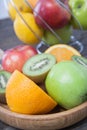 Assortment of exotic fruits close-up: kiwi, red and green apple, oranges and lemon on wooden table. Royalty Free Stock Photo