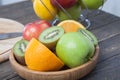 Assortment of exotic fruits close-up: kiwi, red and green apple, oranges and lemon on wooden table. Royalty Free Stock Photo