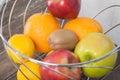 Assortment of exotic fruits close-up: kiwi, red and green apple, oranges and lemon on wooden table. Royalty Free Stock Photo