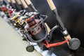 an assortment of fishing reels on the counter of a fishing shop