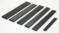 Assortment of flat carbon fiber bars workshop material showcase industrial setting top view versatile applications