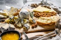 Assortment of French cheese with honey, nuts and figs on cutting board. Gray background. Top view