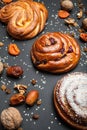 Assortment of fresh baked buns with candied fruits and nuts on a black background Royalty Free Stock Photo