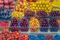 Assortment of fresh berries and fruits at the farmers market with fruits and vegetables, open shelves, display cases. Healthy Royalty Free Stock Photo
