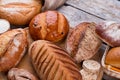 Assortment of fresh crunchy bread on wooden background.