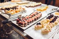 Assortment of fresh desserts displayed in hotel buffet. Variety of cakes in canteen ready for dinner