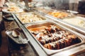 Assortment of fresh dishes displayed in hotel buffet. Variety of food in canteen ready for dinner Royalty Free Stock Photo