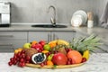 Assortment of fresh exotic fruits on white marble table in kitchen Royalty Free Stock Photo