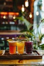 Assortment of fresh fruit juices in clear glasses on rustic wooden tray, healthy drinks concept