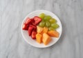Assortment of fresh fruit on a white plate