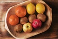 Assortment fresh healthy fruits in handmade wooden bowl made in Royalty Free Stock Photo