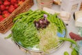 An assortment of fresh herbs and beans on a plate - green micro green leaves and juicy green pea pods. Royalty Free Stock Photo