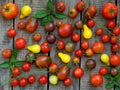 Assortment of fresh organic colorful tomatoes on wooden background. Royalty Free Stock Photo