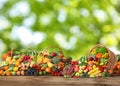 Assortment of fresh organic vegetables and fruits on wooden table against blurred green background Royalty Free Stock Photo