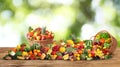 Assortment of fresh organic vegetables and fruits on wooden table against blurred green background. Banner design Royalty Free Stock Photo