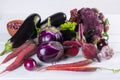 Assortment of fresh raw purple homegrown vegetables on dark wooden table. Royalty Free Stock Photo