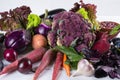 Assortment of fresh raw purple homegrown vegetables on white table. Royalty Free Stock Photo
