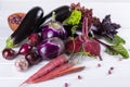 Assortment of fresh raw purple homegrown vegetables on white table. Royalty Free Stock Photo