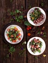 Assortment of fresh vegetable salads flat lay. Top view on vegetarian buffet with tasty side dish variety. Healthy food Royalty Free Stock Photo