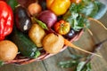 Assortment of fresh vegetables in a basket, bio healthy, organic food on wooden background, country market style, garden produce Royalty Free Stock Photo