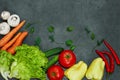 Assortment of fresh vegetables. Carrot lettuce carrots mushrooms tomatoes garlic cucumber concrete Royalty Free Stock Photo