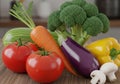 An assortment of fresh vegetables is displayed on a wooden surface Royalty Free Stock Photo