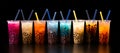 An assortment of fresh, vibrant boba arranged against a sleek black background. Plastic glasses filled with bubble tea