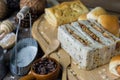 Assortment freshly baked bread rolls lightly dusted with flour on a wooden table