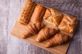 An assortment of freshly baked pastry aligned on cutting board Royalty Free Stock Photo