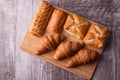 An assortment of freshly baked pastry aligned on cutting board Royalty Free Stock Photo