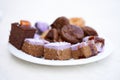 Assortment of freshly prepared organic oriental sweets - cream cakes, Tatar baklava on a white plate. View from above. Royalty Free Stock Photo