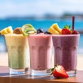 Assortment of fruit smoothies against a beach background. Royalty Free Stock Photo