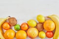 Assortment of fruit tropical fruits orange, tangerine, banana, grapefruit, lemon, lime, kiwi on white background