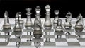 Assortment of glass chess pieces on a board with black and white shade