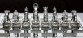 Assortment of glass chess pieces on a board with black and white shade